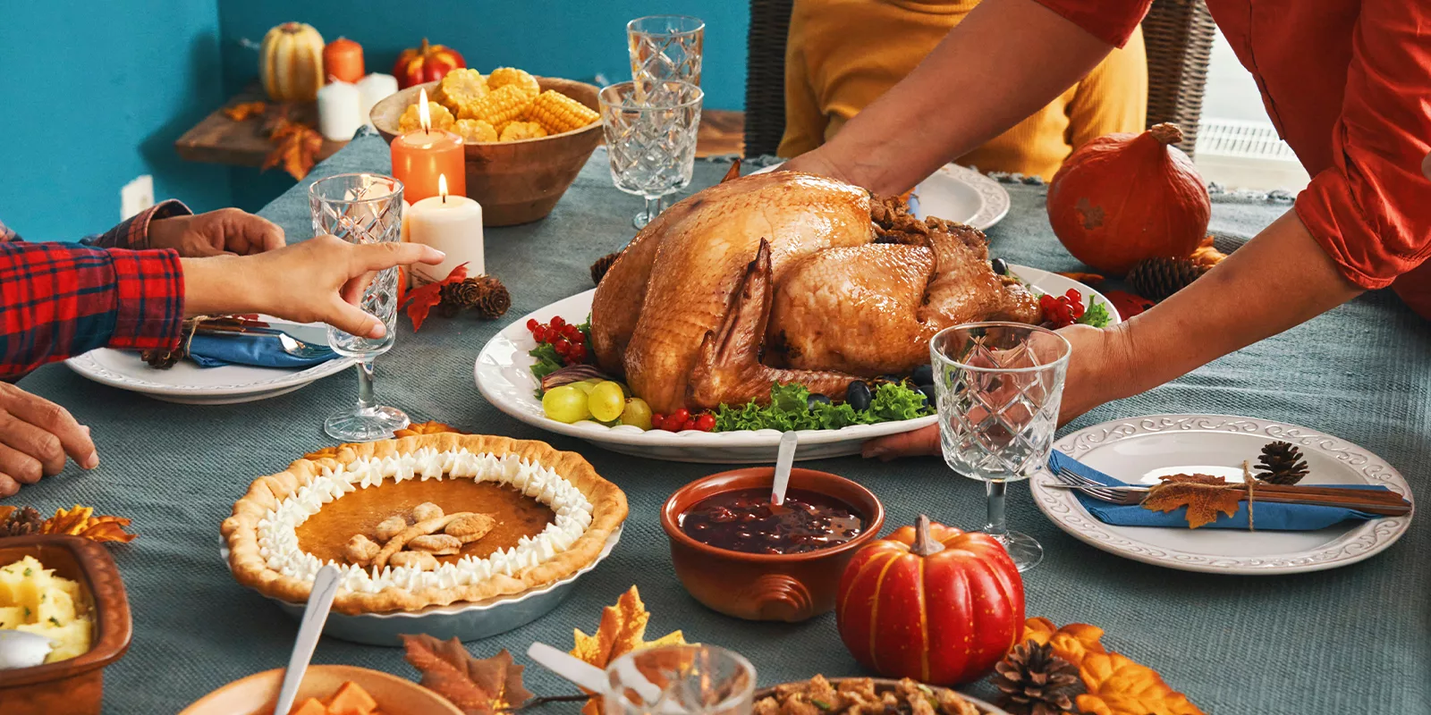 A table full of holiday food looks delicious. A person points to the food they want.