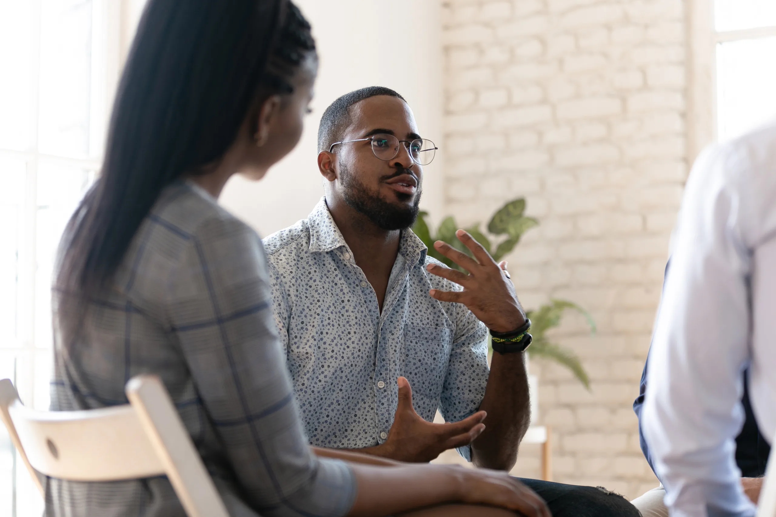 Two people of color in a mental health counseling session environment
