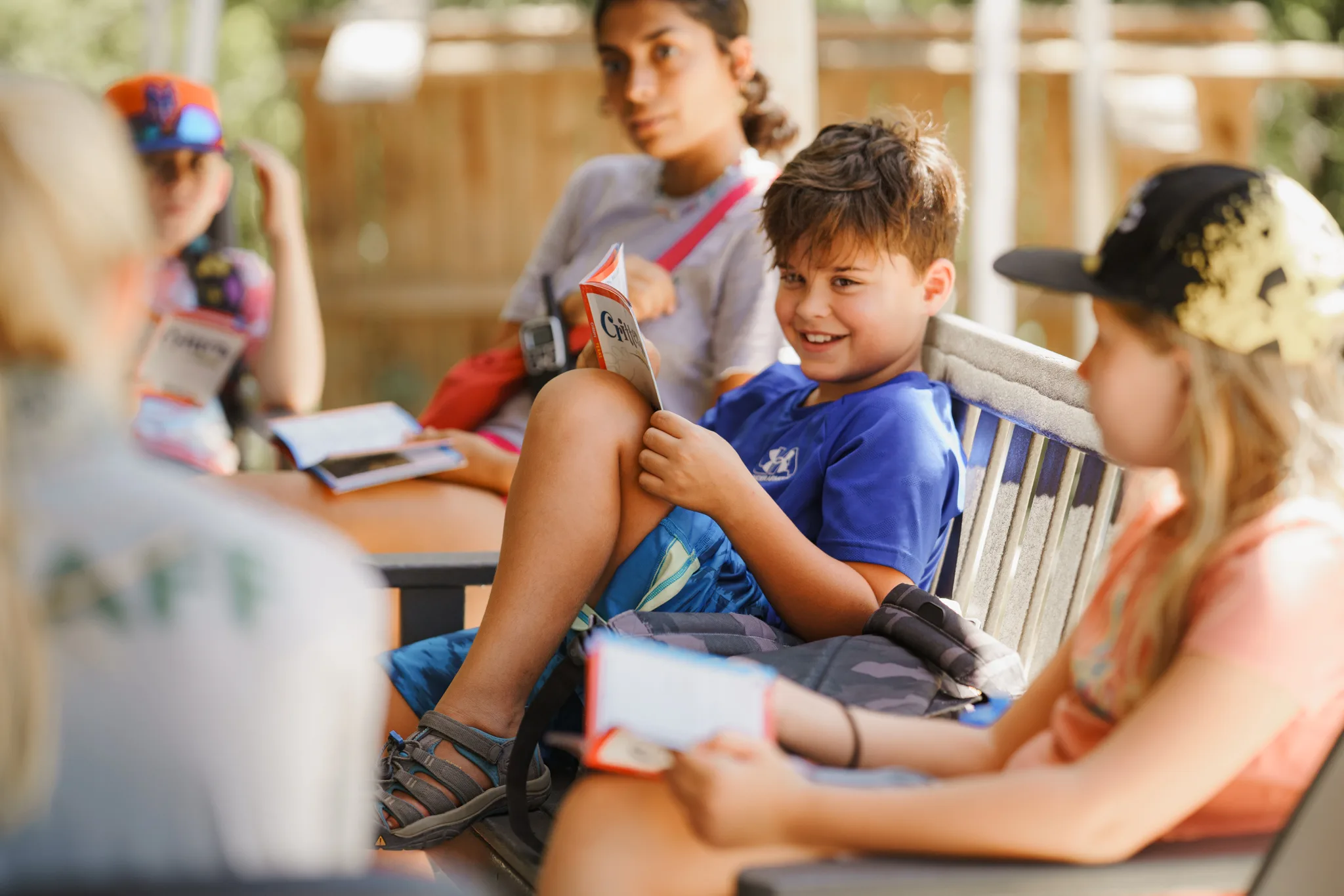 Children sit around a table with open books