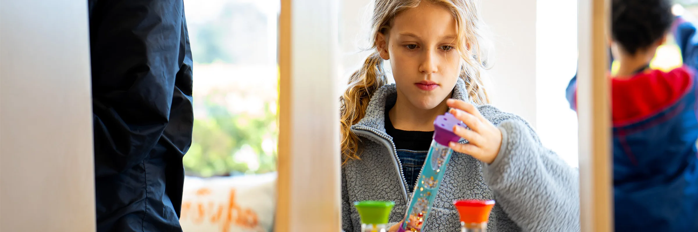 A child plays with a science, technology, engineering and math toy.
