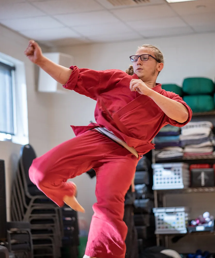 martial-arts-overview-3 A man performs a kick in a martial arts class