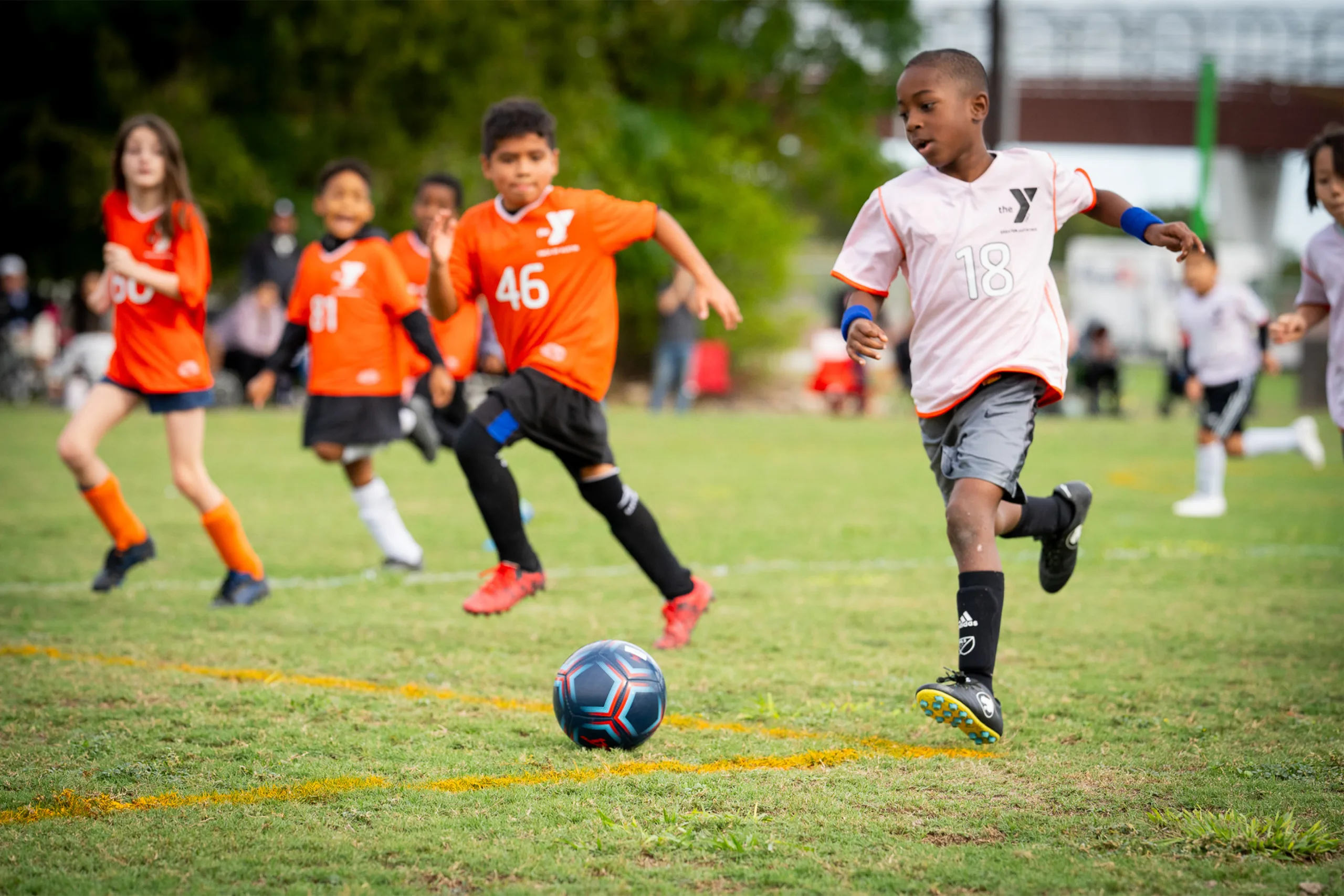 youth-soccer-horizontal-overview-3 Children play a game of soccer outdoors.