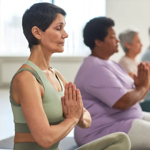 Yoga-Class_Southwest_Overview A woman participating in a group yoga class