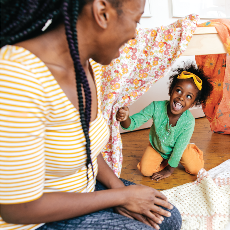 pretendplay3 A parent and child play with a fort made out of sheets