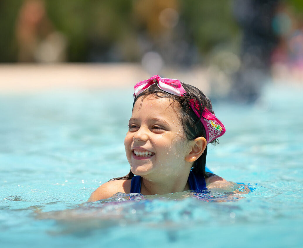 girl swimming in outdoor pool