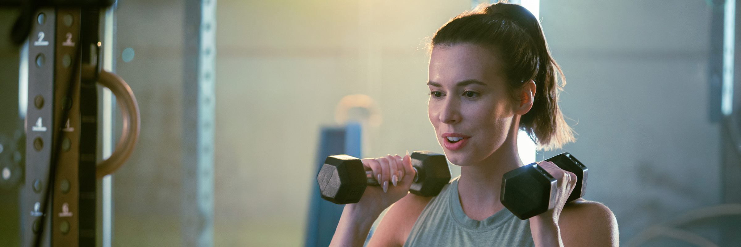 A woman uses dumbbells for a fitness workout.