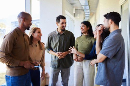 group of couples talking and laughing indoors
