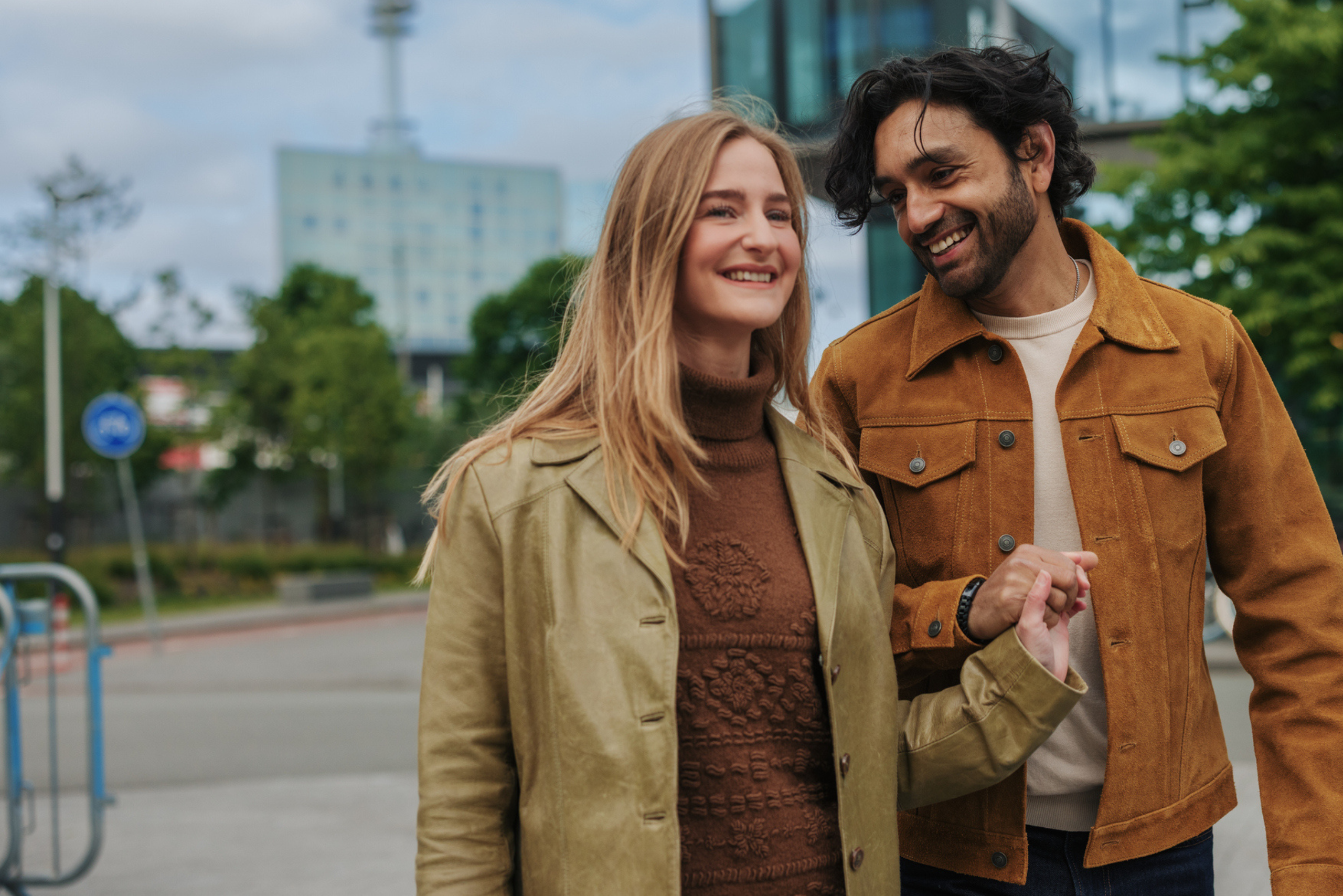 happy couple walking outside and holding hands