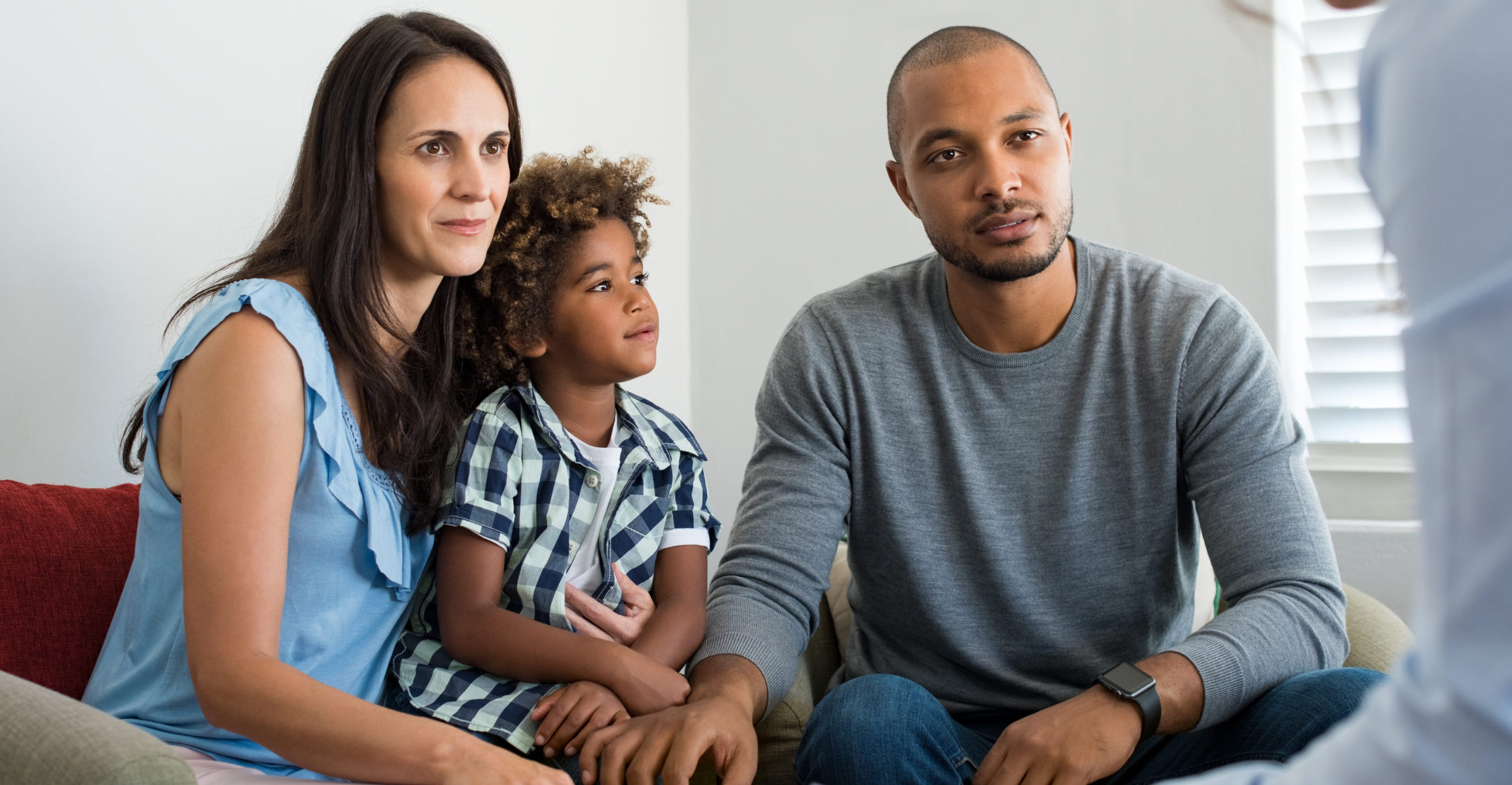 Happy family sitting with counselor during supportive YMCA counseling session