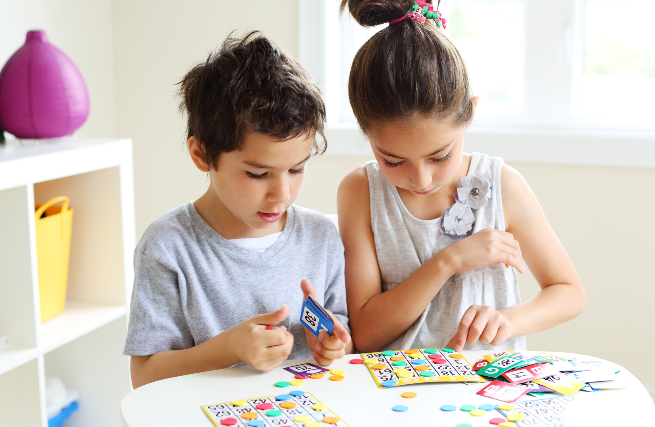 Two kids playing bingo