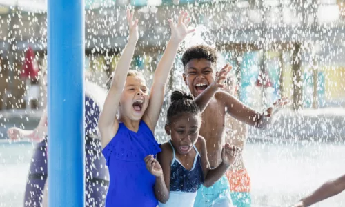Kids splashing in a pool fountain