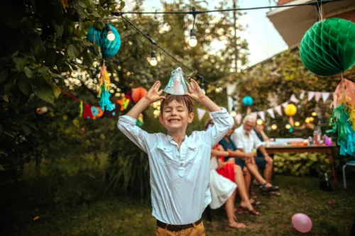 Smiling boy wearing a birthday hat