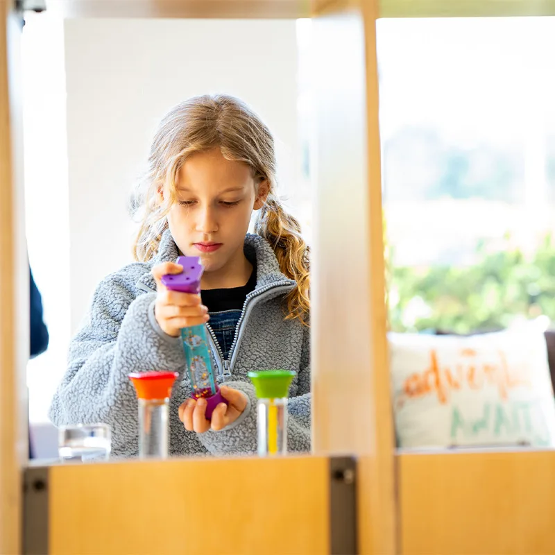 A child plays with a science, technology, engineering and math toy.