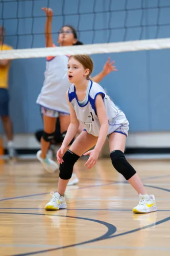 a teen plays a game of volleyball.