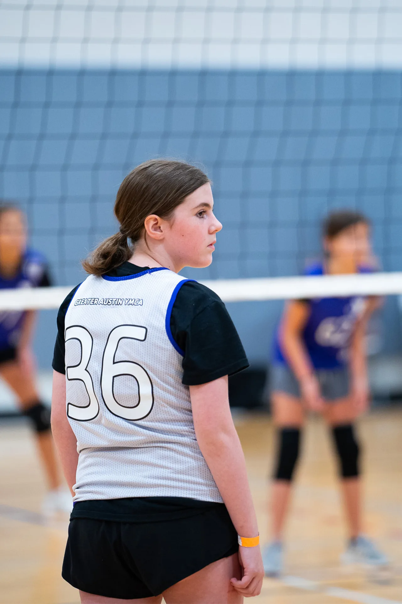 a teen plays a game of volleyball.